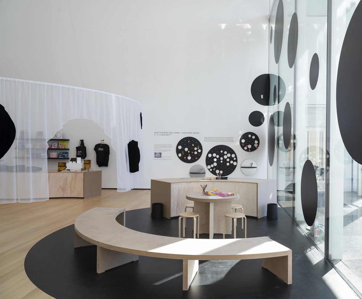 Installation view of One with Eternity: Yayoi Kusama at the Buffalo AKG Art Museum,featuring an activity area with seating and an interactive survey