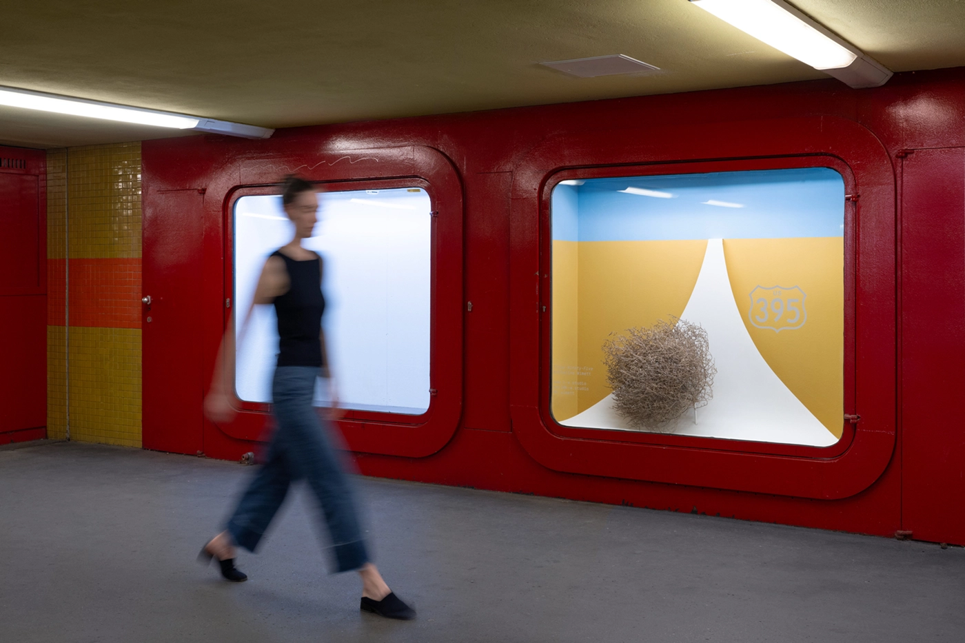 Installation view of 395 at U-bahn Eisenacher Str. in Berlin, featuring a tumbleweed in a constructed highway scene